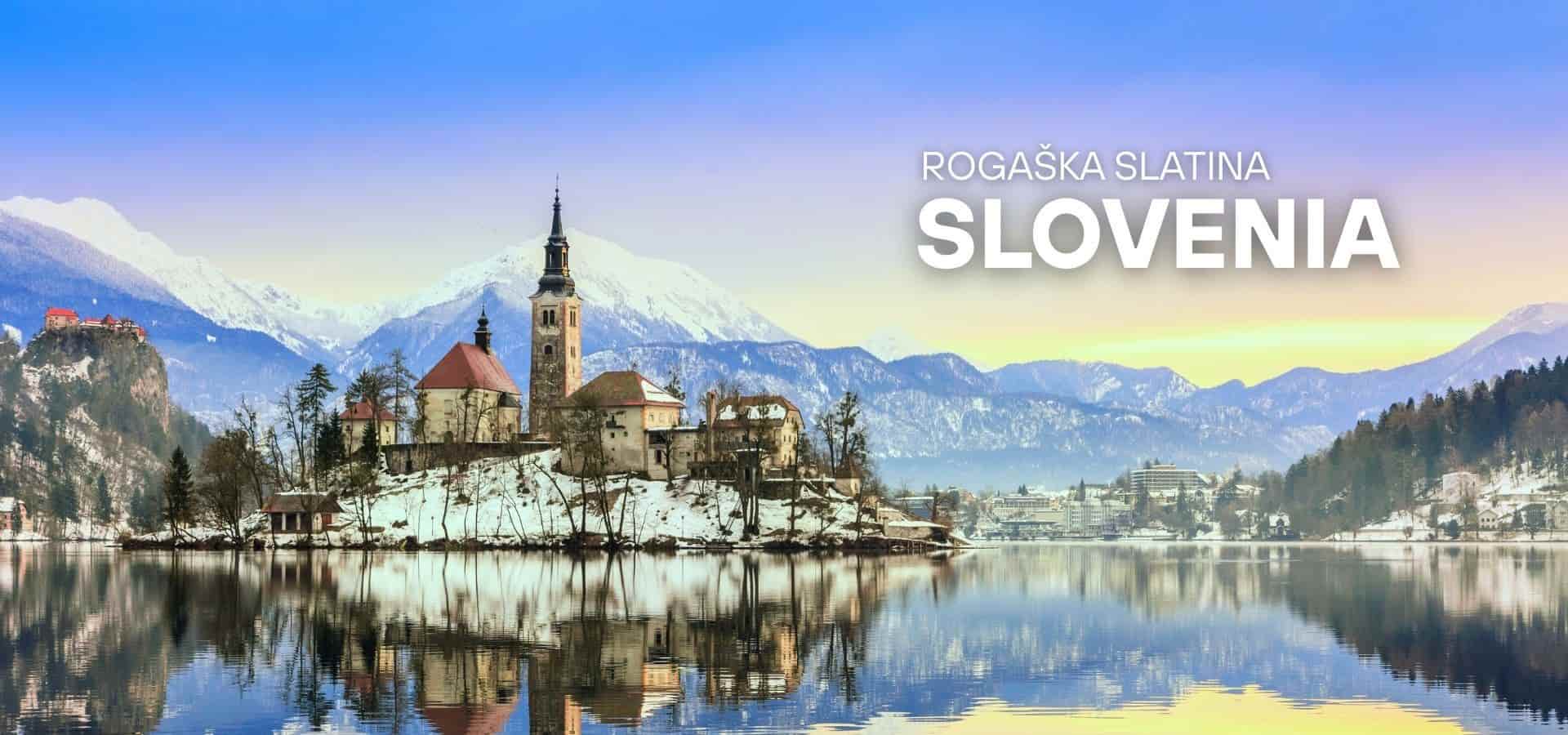 Lake Bled in Slovenia with a church on a small island, snowy mountains in the background, and clear reflections on the water.