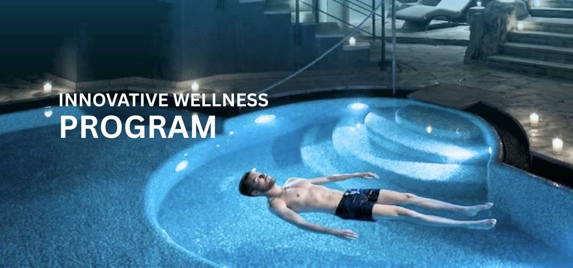 Man relaxing in a softly lit indoor wellness pool during an innovative spa and wellness program.