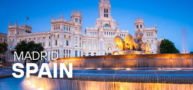 Evening view of Cibeles Fountain and Palacio de Cibeles in Madrid, Spain, illuminated with city lights and the text “Madrid Spain.”