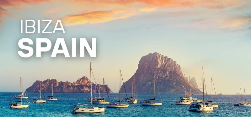Sunset view of Ibiza, Spain with sailboats on turquoise water and the rocky island of Es Vedrà in the background, with “Ibiza Spain” text overlay.