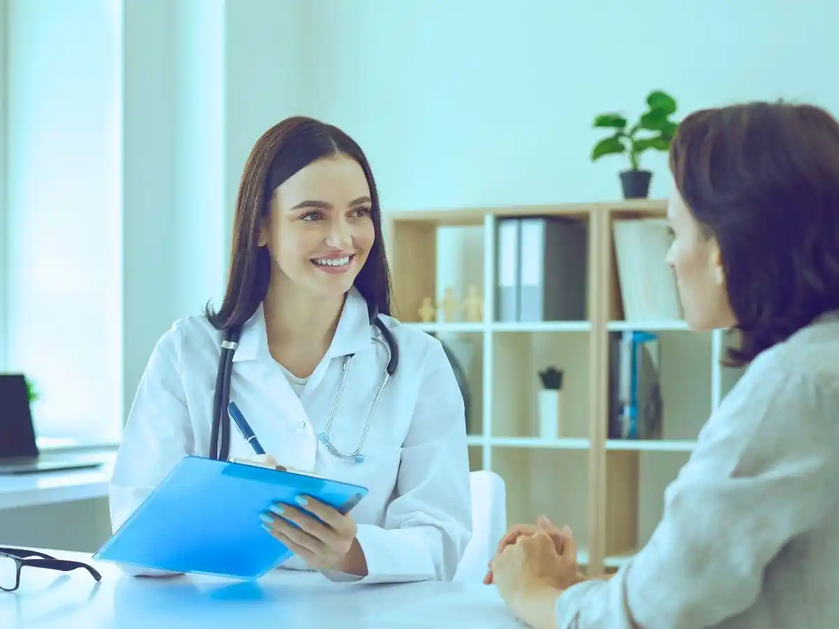 Doctor discussing treatment options with a female patient during a medical consultation.