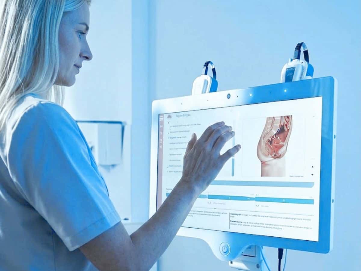 Healthcare professional using a digital medical screen to review patient diagnostics and health data, showing advanced clinical technology in a modern longevity clinic.